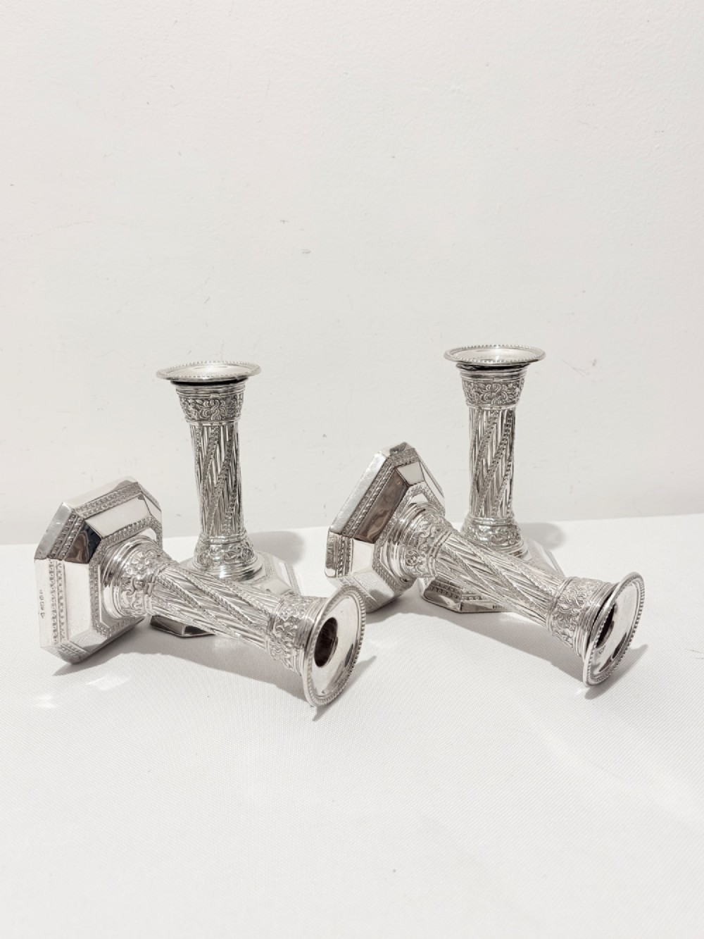 A set of four matching silver column candlesticks with spiral fluted stems and decorated octagonal bases. View V