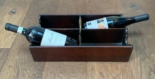 fig 1. A George III dark mahogany four-section wine bottle caddy featuring a central brass carrying handle and shaped side galleries.
