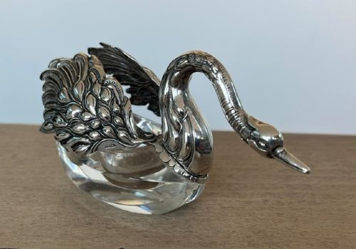 A clear crystal swan salt cellar featuring articulated sterling silver wings and a sculpted silver neck. View V