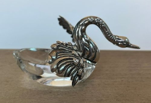 A clear crystal swan salt cellar featuring articulated sterling silver wings and a sculpted silver neck. View VI
