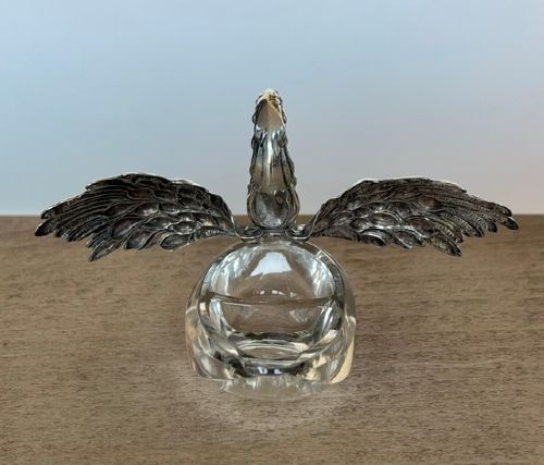 A clear crystal swan salt cellar featuring articulated sterling silver wings and a sculpted silver neck. View VII