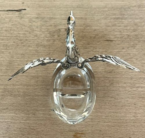 A clear crystal swan salt cellar featuring articulated sterling silver wings and a sculpted silver neck. View VIII
