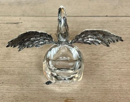 A clear crystal swan salt cellar featuring articulated sterling silver wings and a sculpted silver neck. View IX