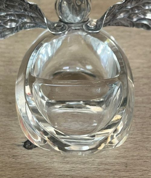 A clear crystal swan salt cellar featuring articulated sterling silver wings and a sculpted silver neck. View X