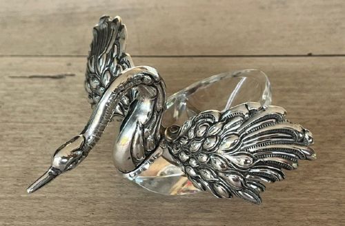 A clear crystal swan salt cellar featuring articulated sterling silver wings and a sculpted silver neck. View XI