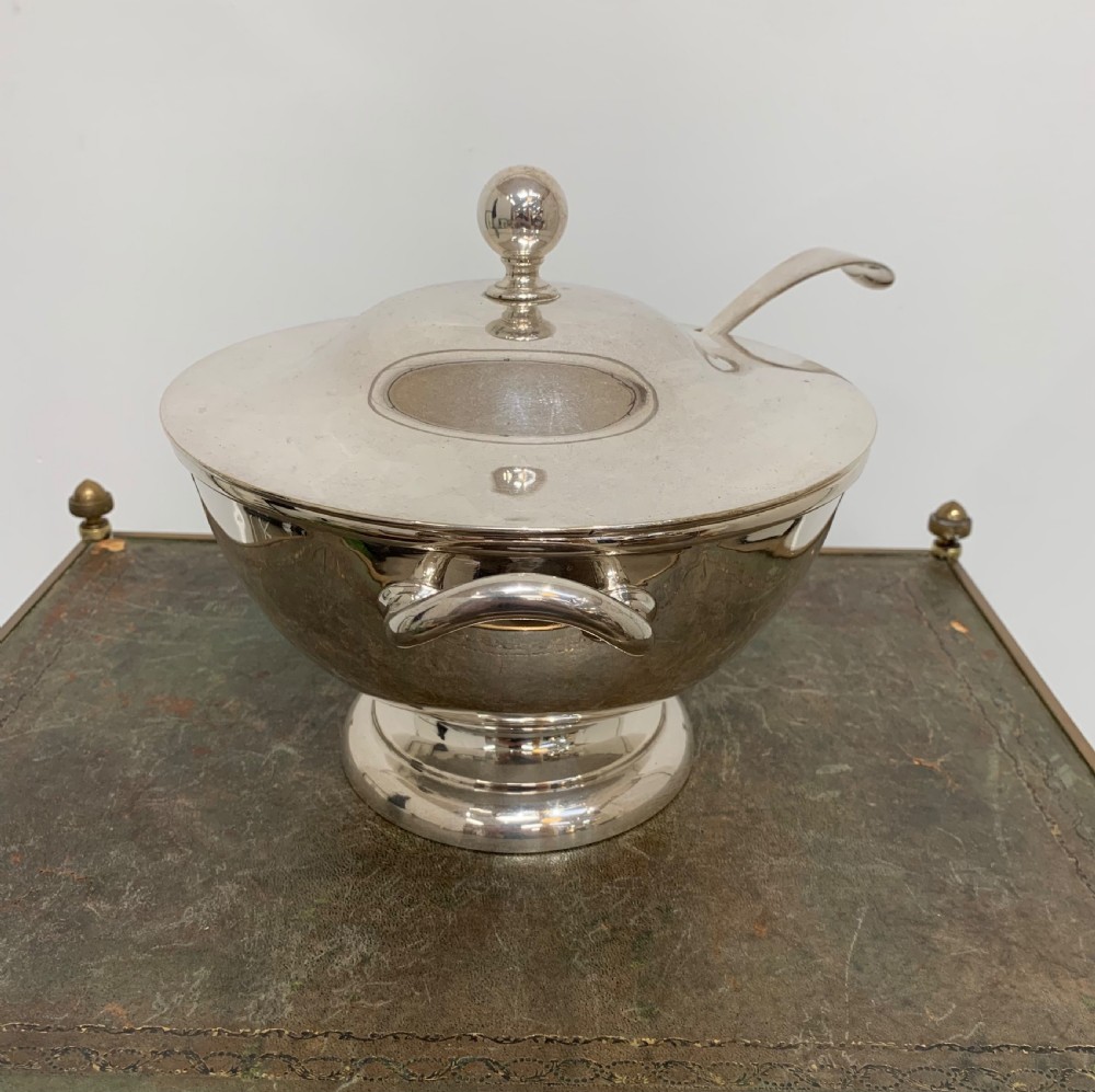 A Victorian silver-plated two-handled soup tureen featuring a domed lid, spherical finial, matching ladle, and pedestal base. View II