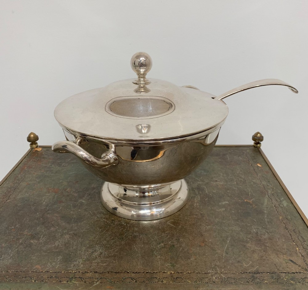 A Victorian silver-plated two-handled soup tureen featuring a domed lid, spherical finial, matching ladle, and pedestal base. View IV