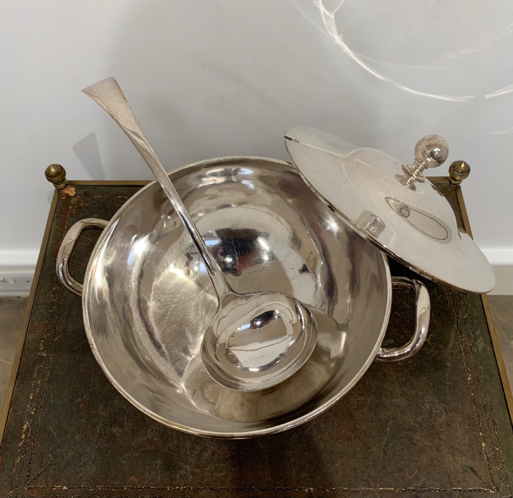 A Victorian silver-plated two-handled soup tureen featuring a domed lid, spherical finial, matching ladle, and pedestal base. View VI