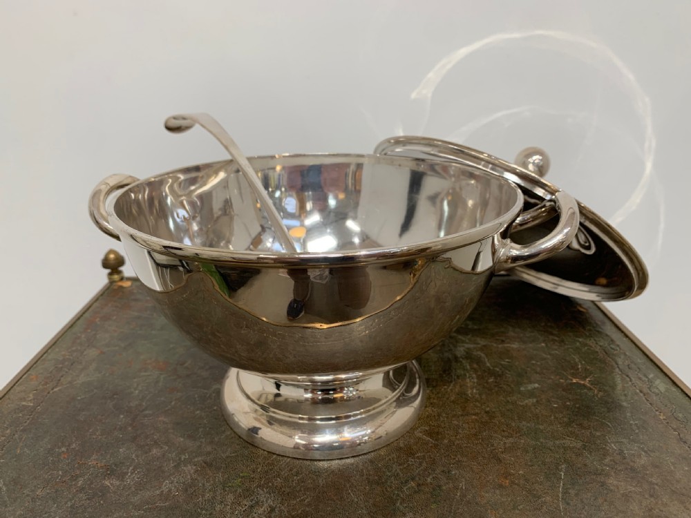 A Victorian silver-plated two-handled soup tureen featuring a domed lid, spherical finial, matching ladle, and pedestal base. View VII