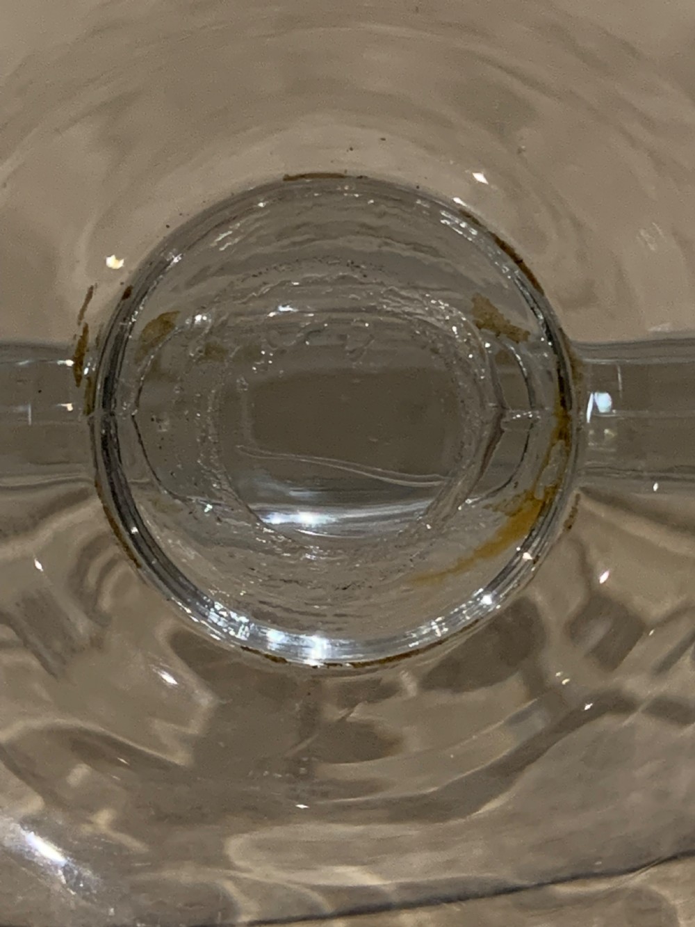 A clear glass Art Deco circular ashtray featuring an upright circular medallion with a frosted relief depicting a centaur holding a javelin above the lettering REMY MARTIN V.S.O.P. View VIII
