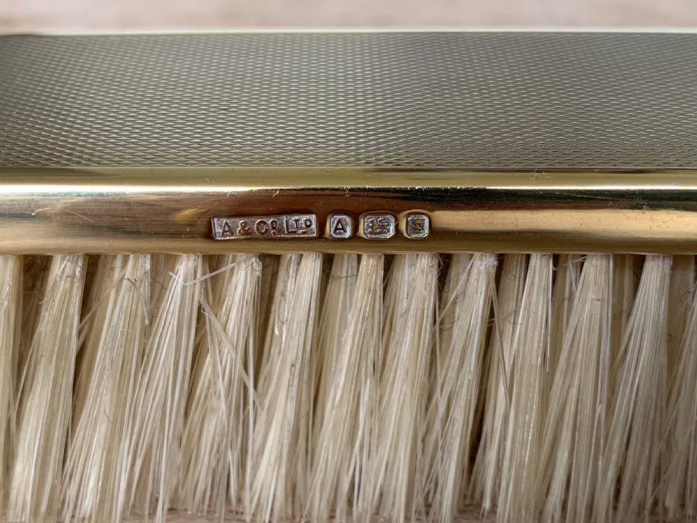 An Art Deco engine-turned silver-gilt rectangular clothes brush by Asprey with dense light-coloured natural bristles. View III