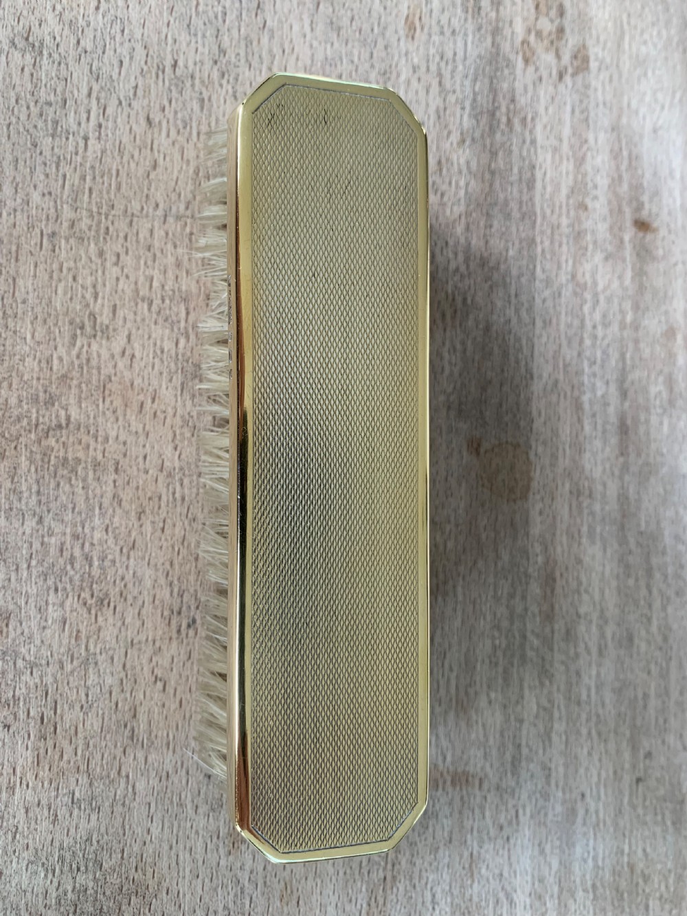 An Art Deco engine-turned silver-gilt rectangular clothes brush by Asprey with dense light-coloured natural bristles. View IV