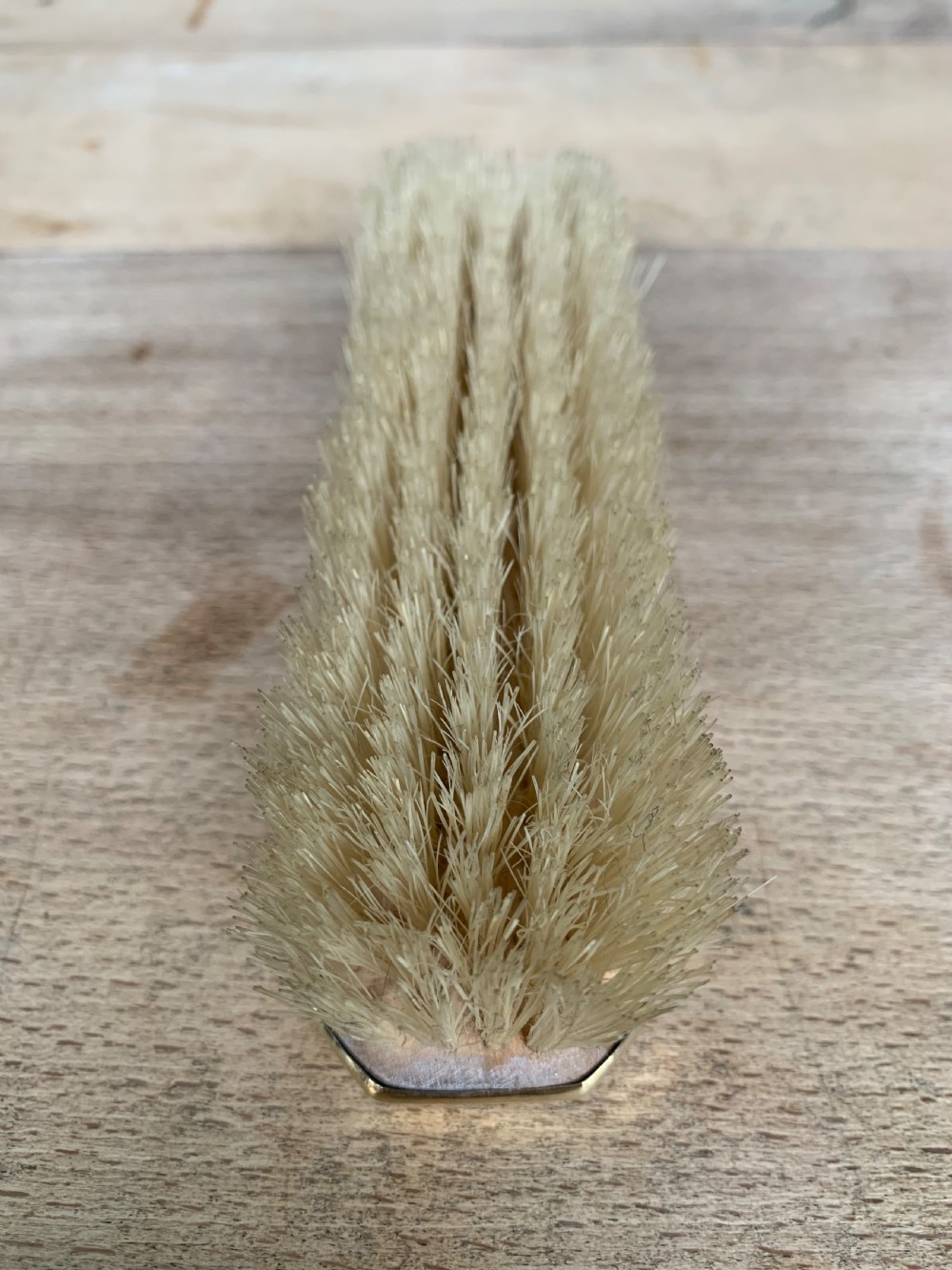An Art Deco engine-turned silver-gilt rectangular clothes brush by Asprey with dense light-coloured natural bristles. View VII
