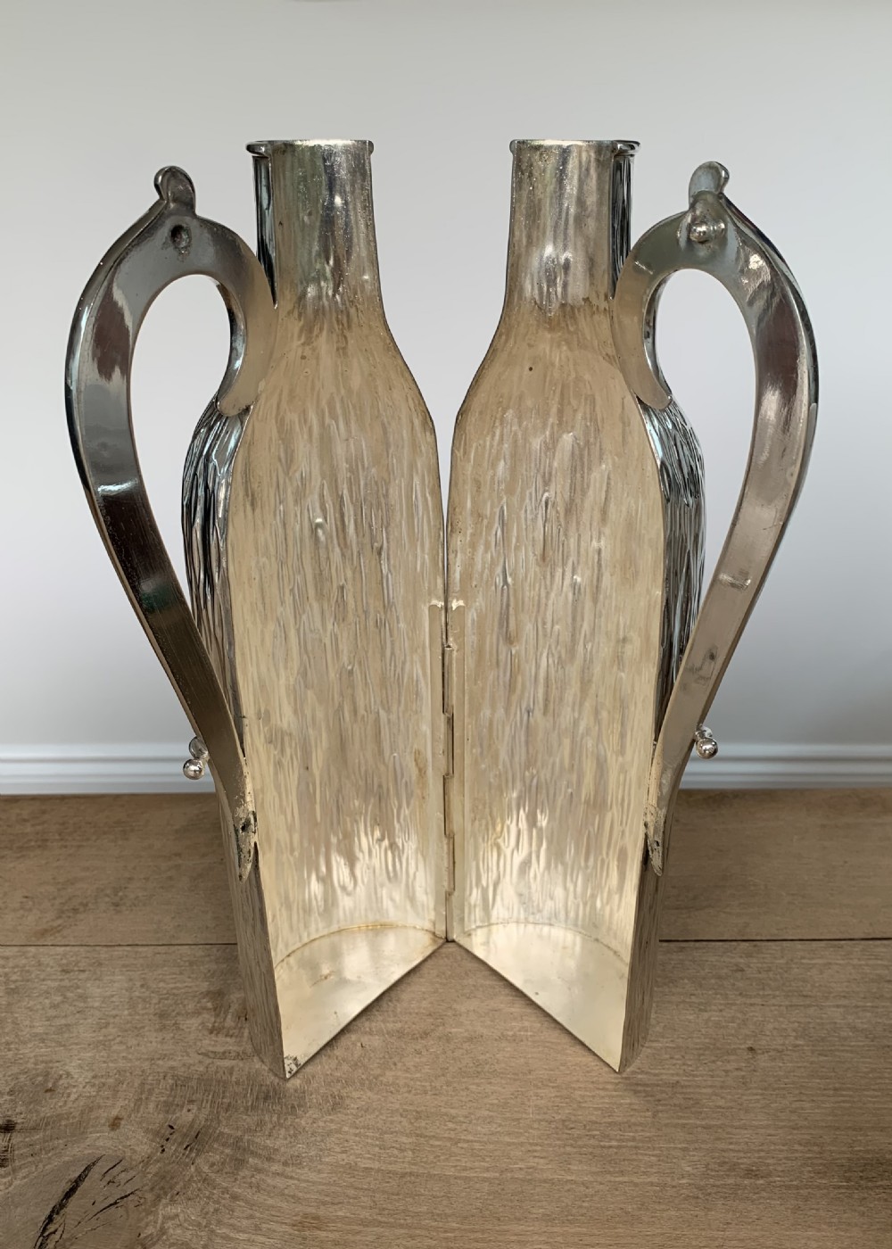 A 19th-century silver-plated wine bottle holder featuring a textured bark effect finish and a long sweeping curved handle. View IV