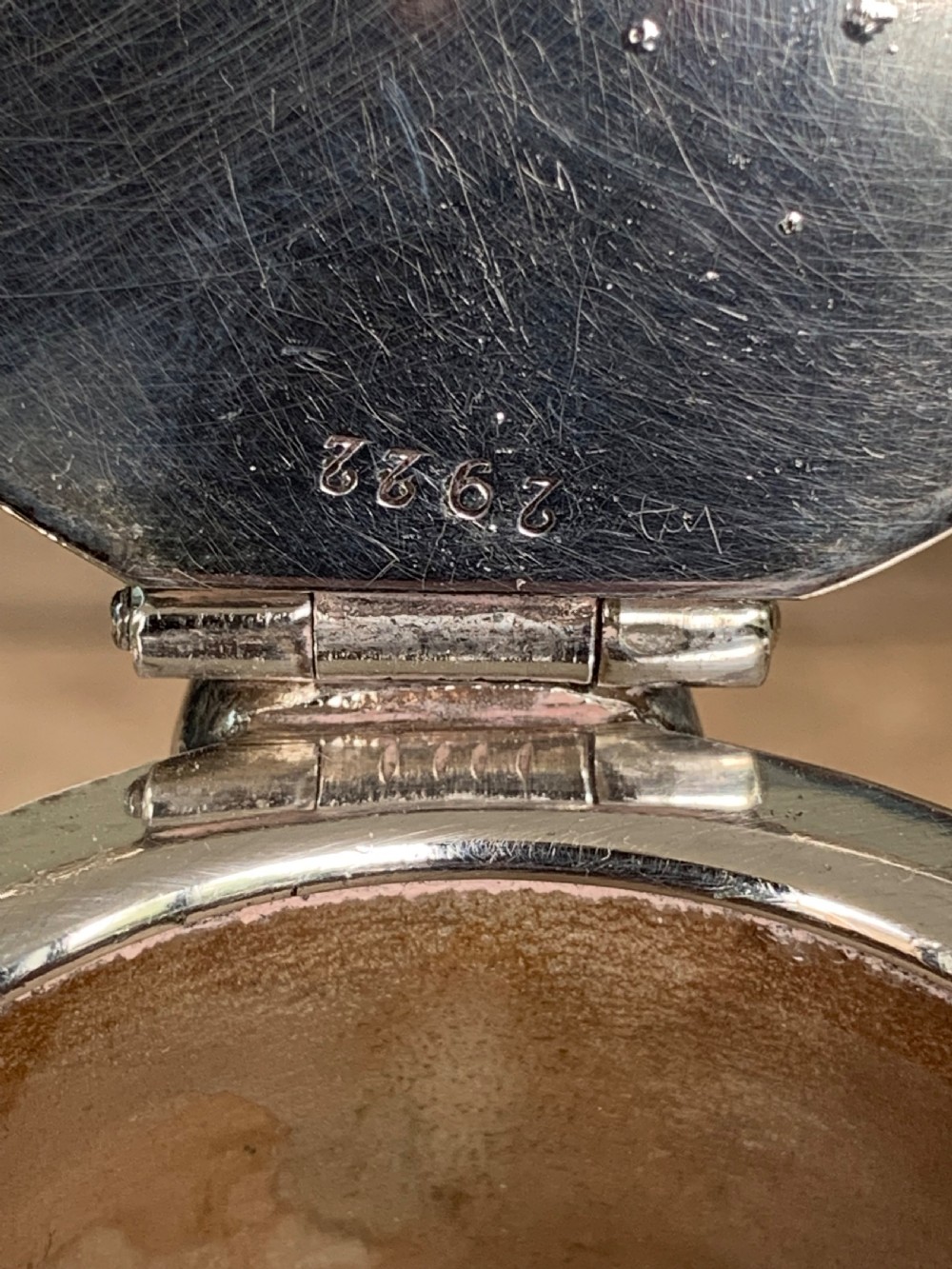 A clear spherical glass claret jug featuring a silver-plated collar, flat hinged cap, angular handle, and a cut starburst pattern on the base. View XI