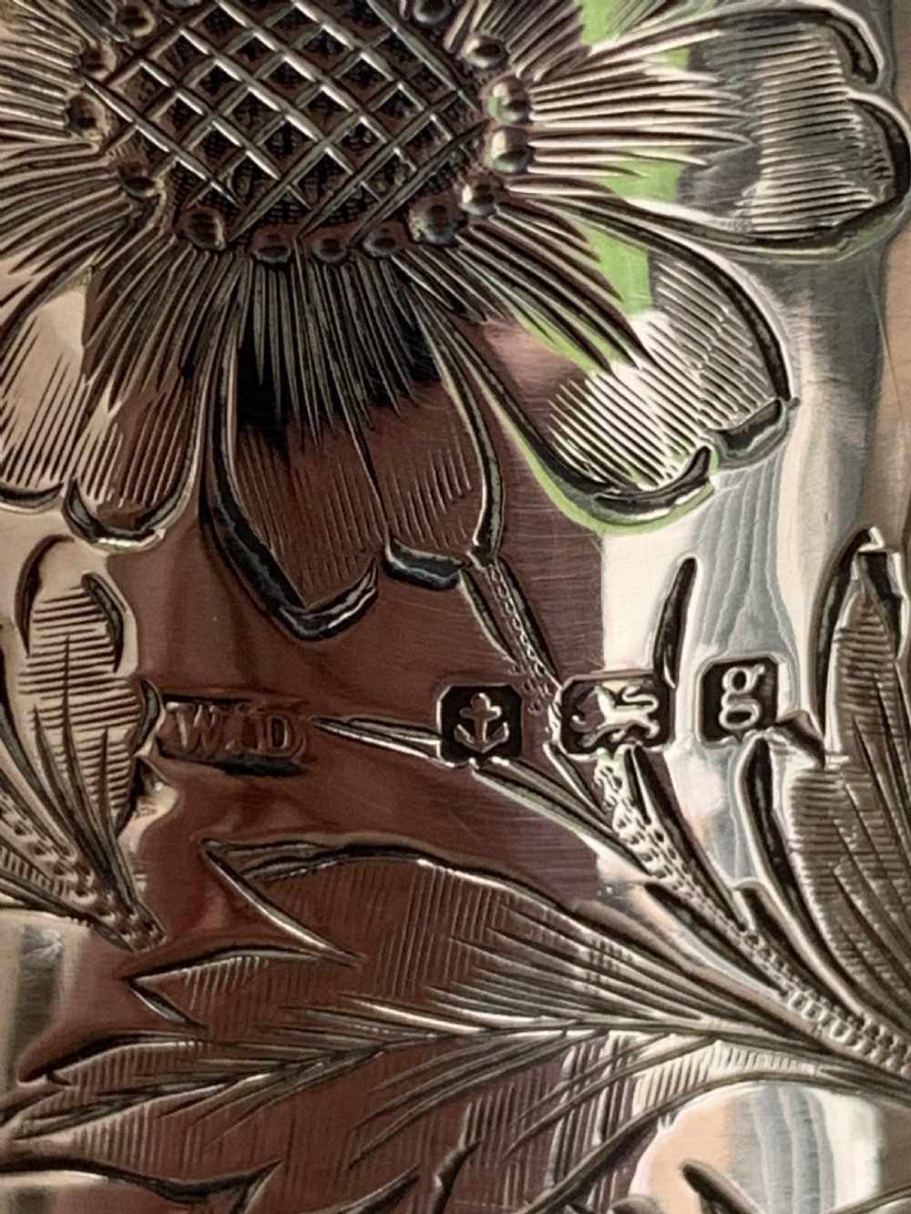 An Edwardian clear glass claret jug featuring wheel-engraved daisy motifs and a hallmarked sterling silver collar with handle. View VIII