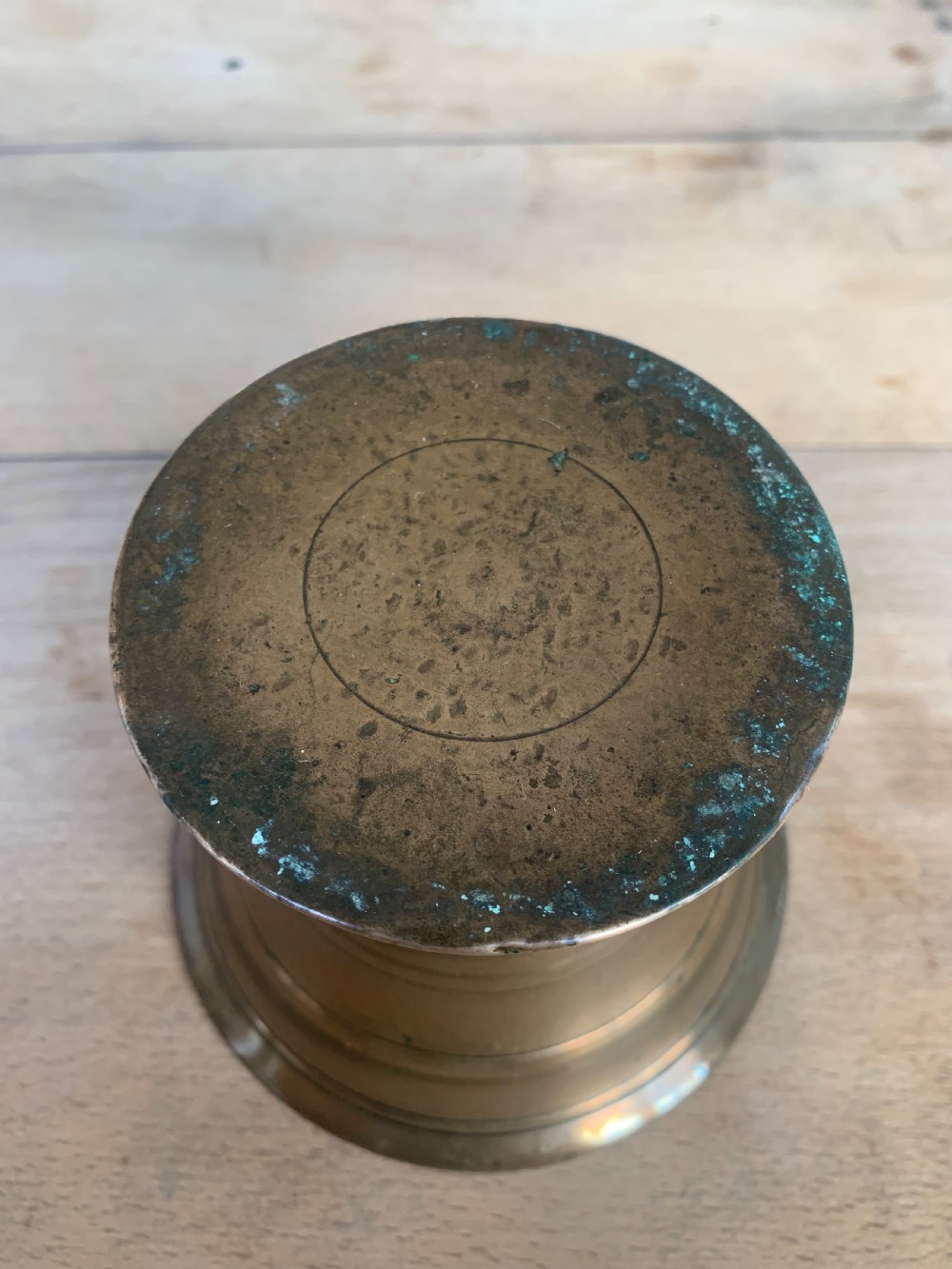 An antique cast bronze mortar with a flared rim and turned waist, accompanied by a matching metal pestle. View II
