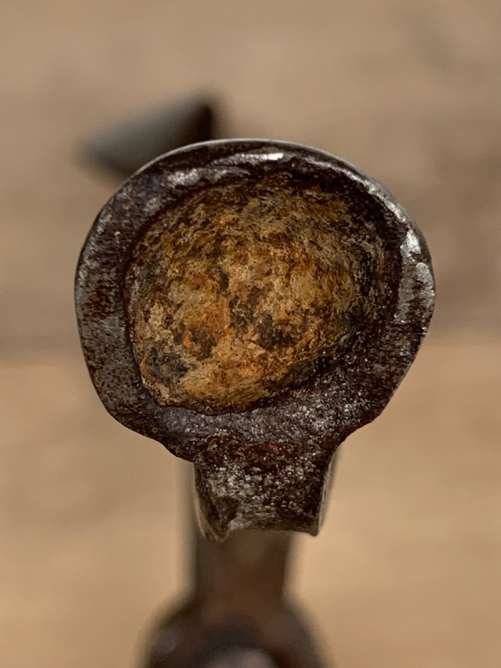 A hand-forged wrought iron rushlight holder featuring a sprung pincer clamp mechanism raised on a curved tripod base. View XI
