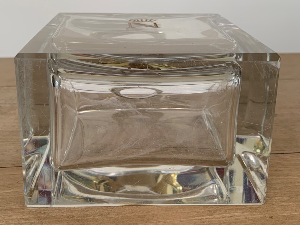 A square clear crystal brandy decanter featuring a silver-gilt collar around the neck, a crowned N monogram on the body, and a rectangular stopper. View IV