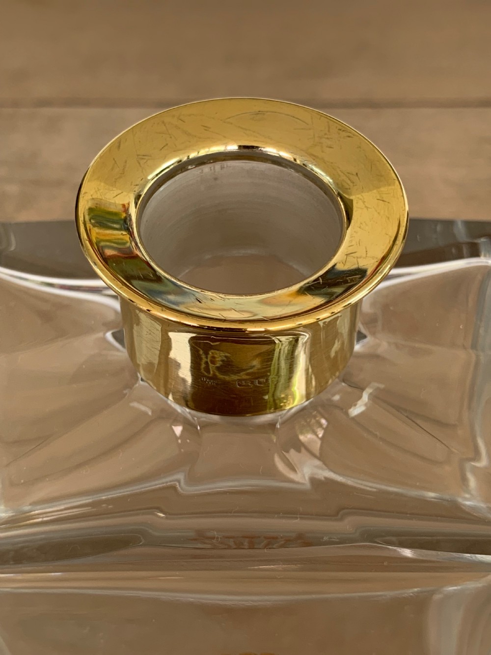 A square clear crystal brandy decanter featuring a silver-gilt collar around the neck, a crowned N monogram on the body, and a rectangular stopper. View III