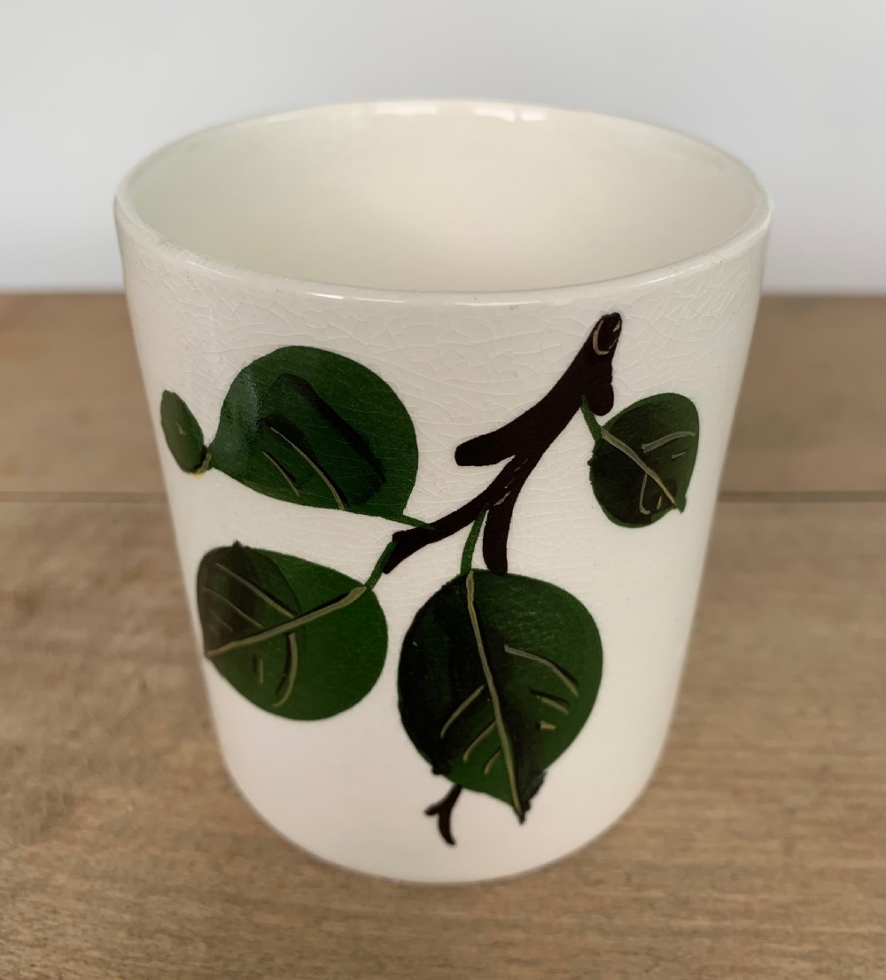 A lidded white ceramic preserve pot decorated with hand-painted red cherries and green leaves, featuring a notch for a spoon. View III