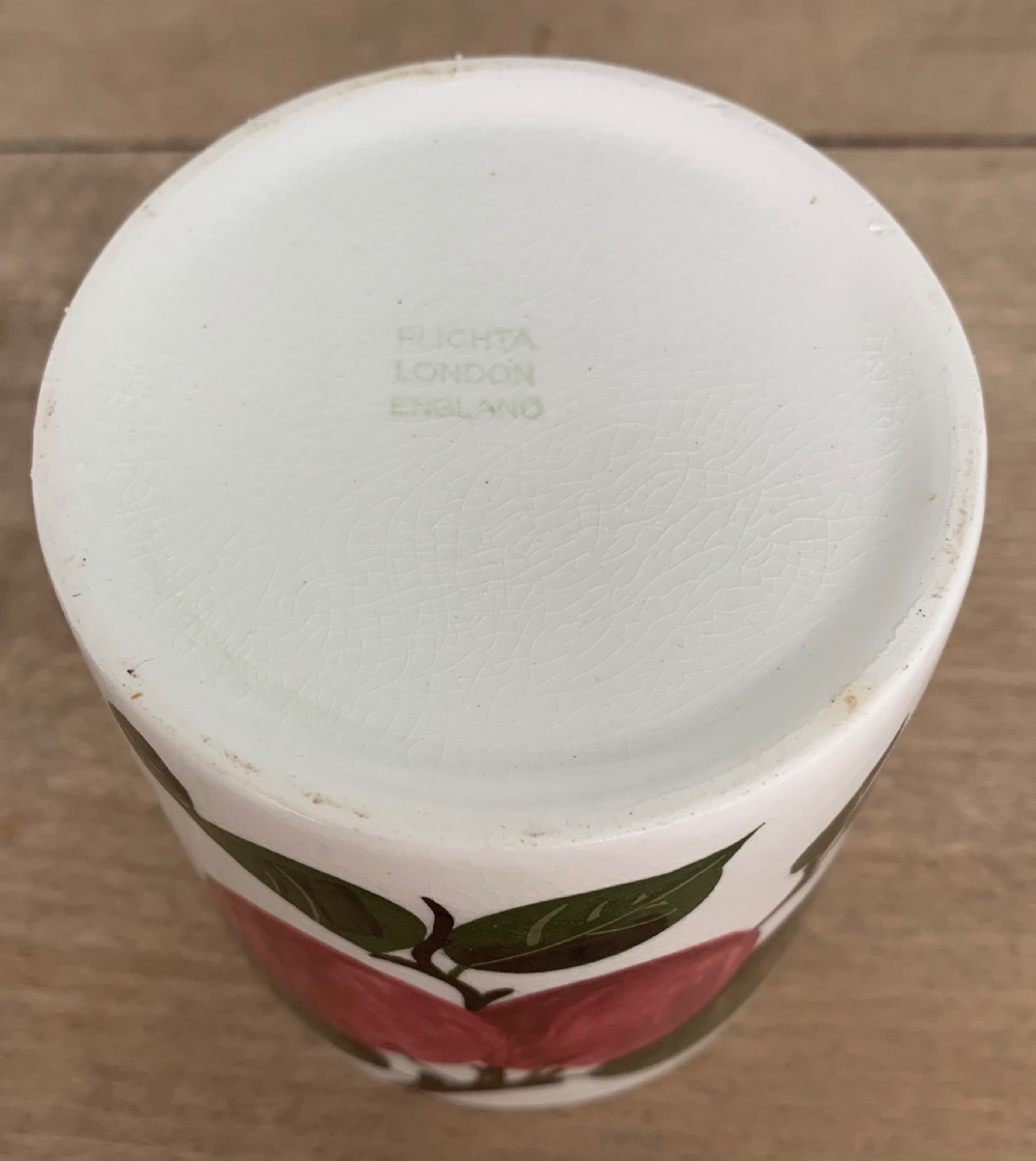 A lidded white ceramic preserve pot decorated with hand-painted red cherries and green leaves, featuring a notch for a spoon. View IV