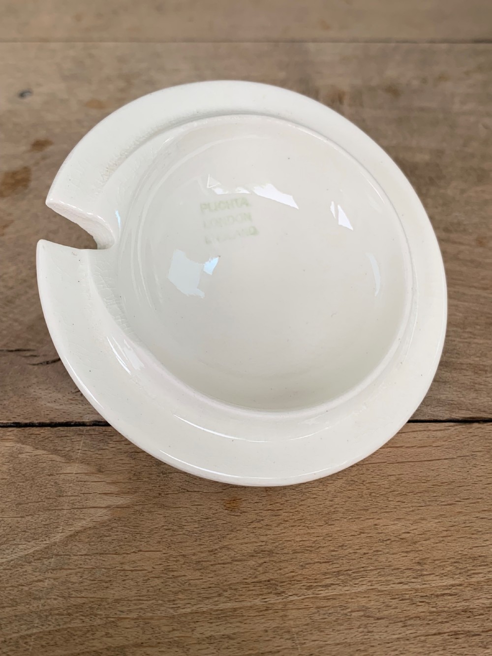 A lidded white ceramic preserve pot decorated with hand-painted red cherries and green leaves, featuring a notch for a spoon. View IX
