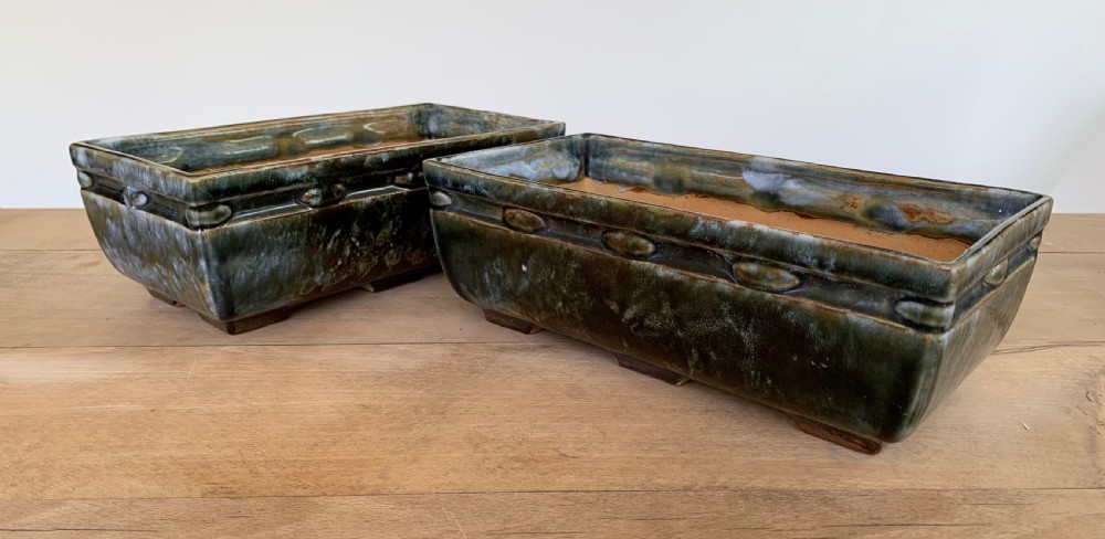 A pair of rectangular stoneware bonsai planters featuring a mottled olive-green drip glaze and embossed beaded rim details.