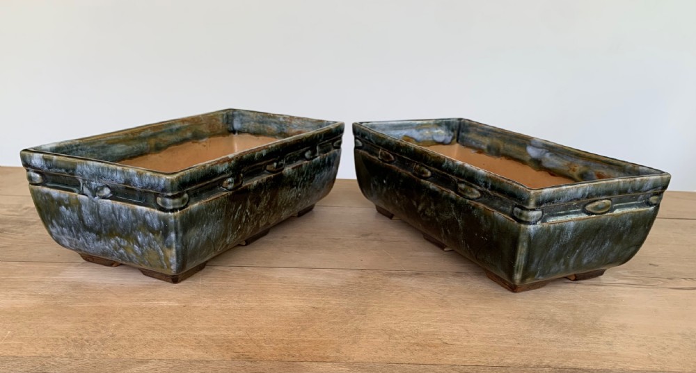 A pair of rectangular stoneware bonsai planters featuring a mottled olive-green drip glaze and embossed beaded rim details. View IV