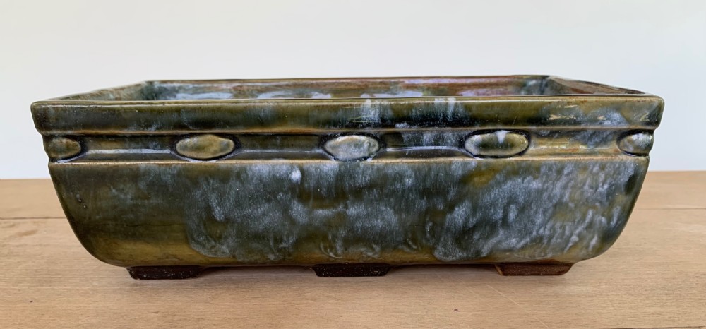 A pair of rectangular stoneware bonsai planters featuring a mottled olive-green drip glaze and embossed beaded rim details. View VIII