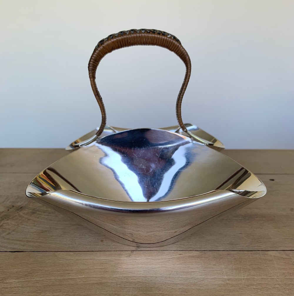 A late Victorian silver-plated twin bon-bon dish with scoop-shaped bowls and a central overhead cane-wrapped arch handle. View IX