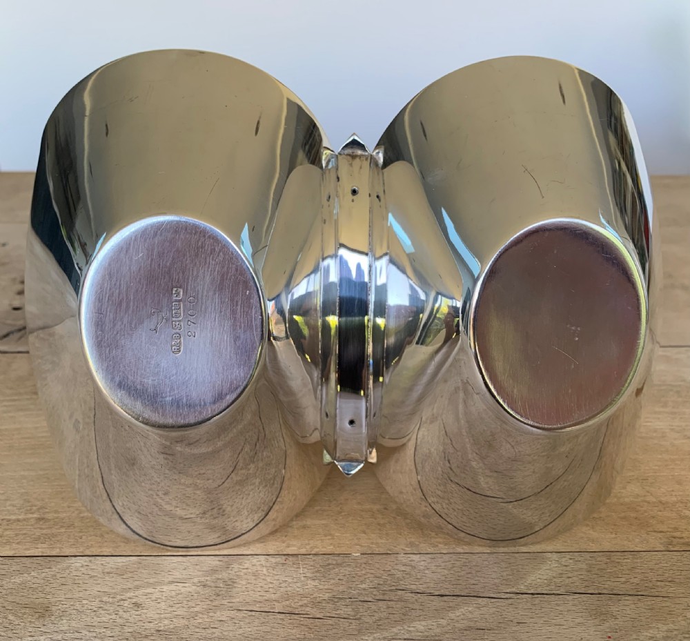 A late Victorian silver-plated twin bon-bon dish with scoop-shaped bowls and a central overhead cane-wrapped arch handle. View X