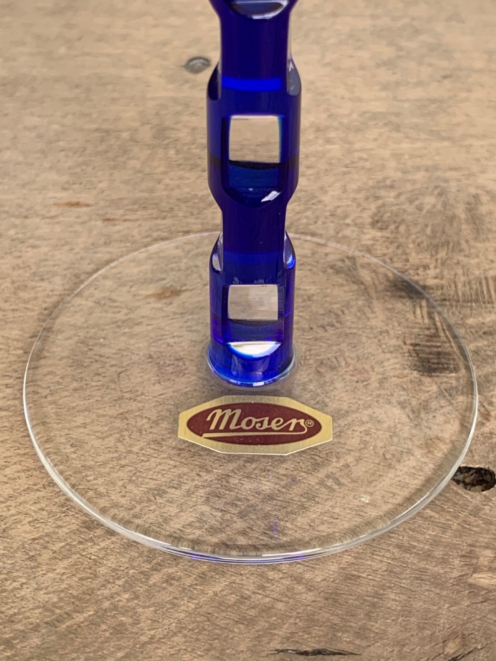 Pair of cobalt blue cut-to-clear crystal champagne flutes featuring geometric architectural patterns and notched square stems on round clear bases. View XV