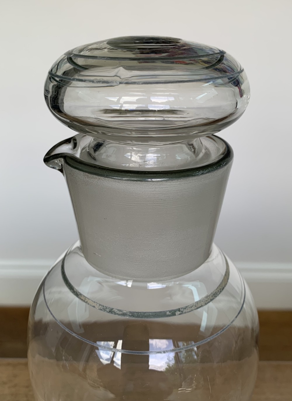 A clear glass Art Deco cocktail shaker featuring a ground glass neck, silver painted lines, and a hand-painted white cockerel motif with a red comb. View III