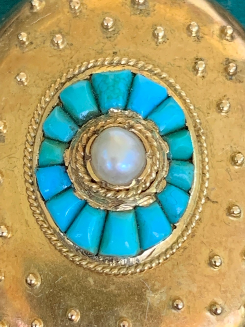 An oval 18ct yellow gold antique photo locket decorated with beaded granulation and a central turquoise and pearl target cluster. View III
