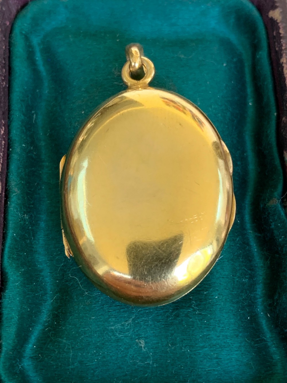 An oval 18ct yellow gold antique photo locket decorated with beaded granulation and a central turquoise and pearl target cluster. View IV