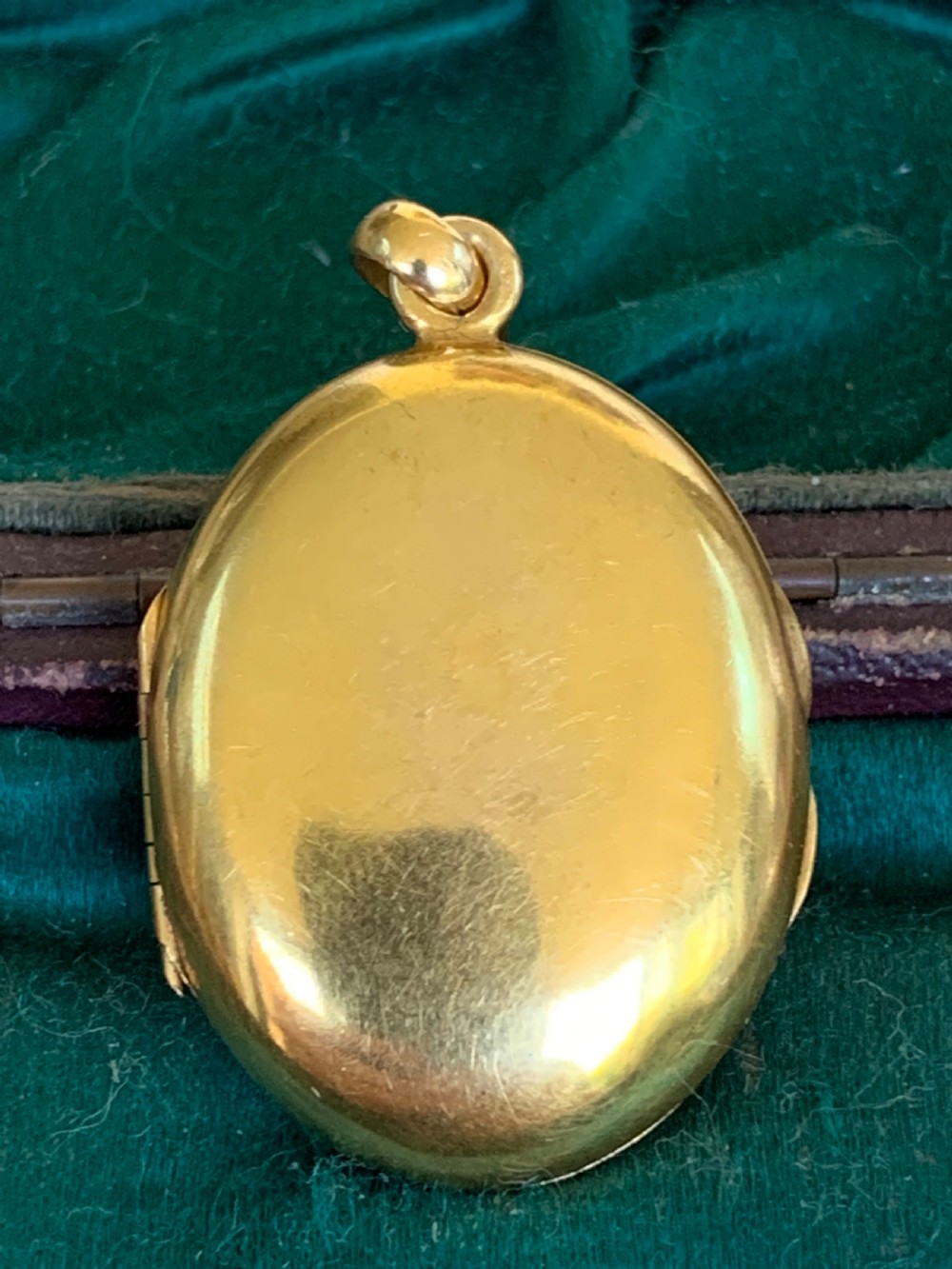 An oval 18ct yellow gold antique photo locket decorated with beaded granulation and a central turquoise and pearl target cluster. View V