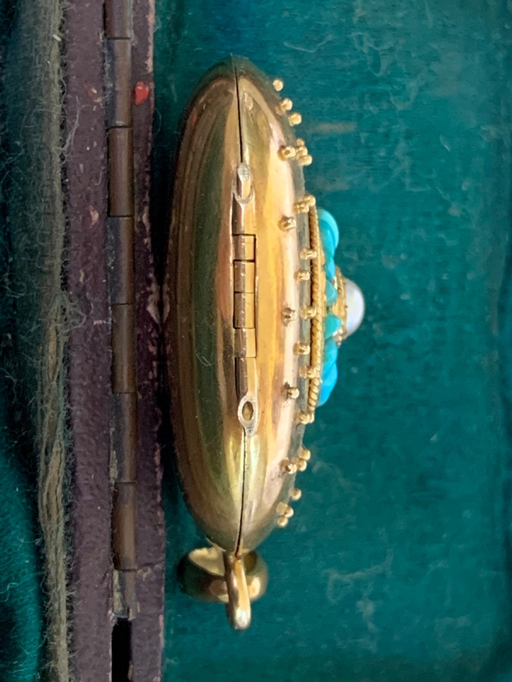 An oval 18ct yellow gold antique photo locket decorated with beaded granulation and a central turquoise and pearl target cluster. View VII