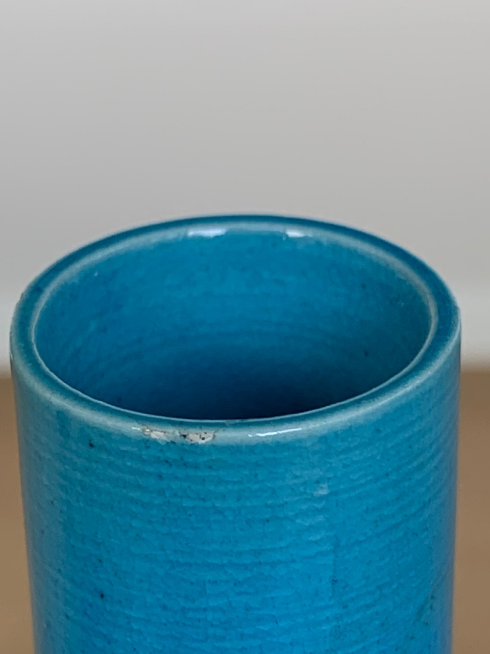 A turquoise blue Chinese porcelain bottle vase featuring a long cylindrical neck, rounded body, and incised peony motifs beneath a glossy glaze. View IX