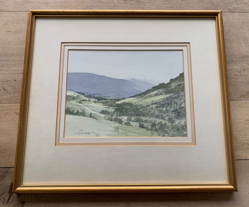 A framed watercolour landscape painting depicting rolling green hills and distant grey mountains near Killin, Scotland, signed by Stanley Orchart. View II