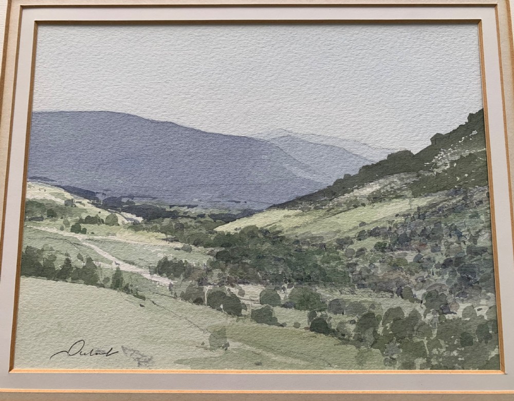 A framed watercolour landscape painting depicting rolling green hills and distant grey mountains near Killin, Scotland, signed by Stanley Orchart. View III
