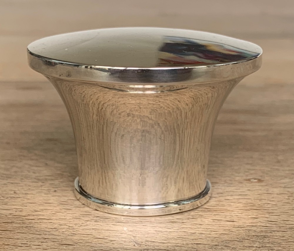 A spherical clear cut glass scent bottle featuring diamond patterns and a polished sterling silver neck collar and lid. View IX