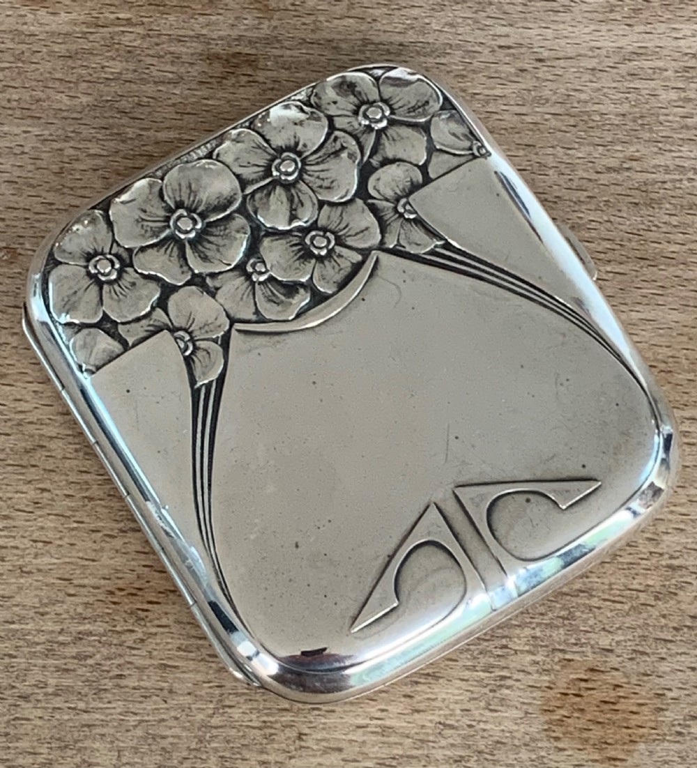 An antique German silver cigarette case featuring embossed Jugendstil floral motifs and flowing organic lines. View II