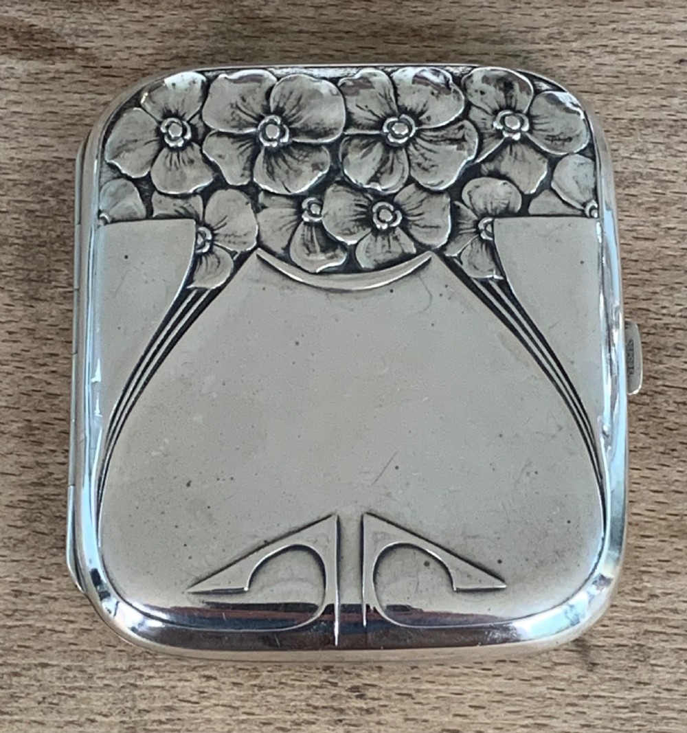 An antique German silver cigarette case featuring embossed Jugendstil floral motifs and flowing organic lines. View III