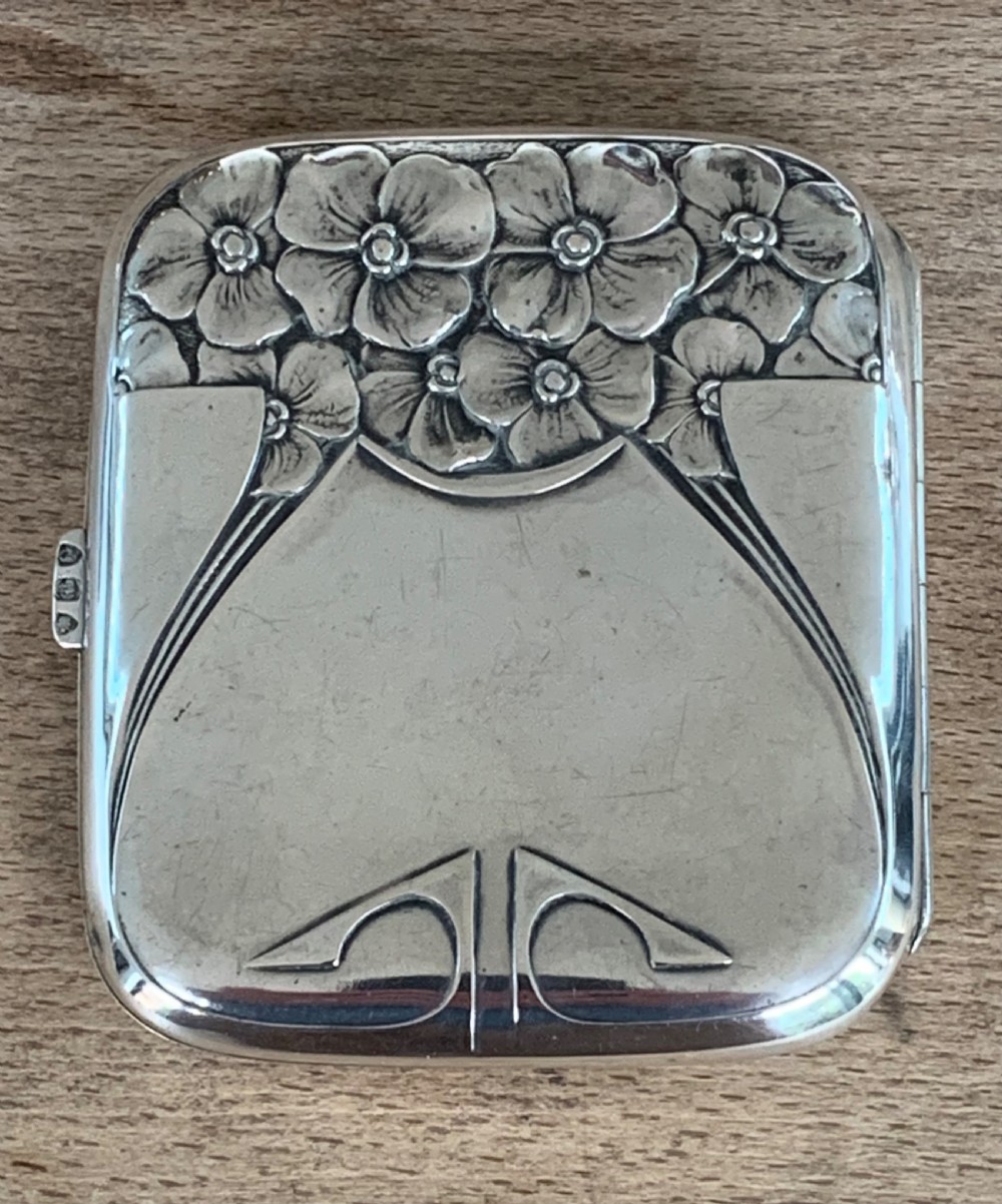An antique German silver cigarette case featuring embossed Jugendstil floral motifs and flowing organic lines. View IV