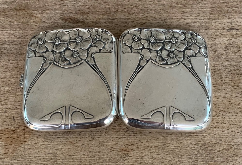An antique German silver cigarette case featuring embossed Jugendstil floral motifs and flowing organic lines. View V