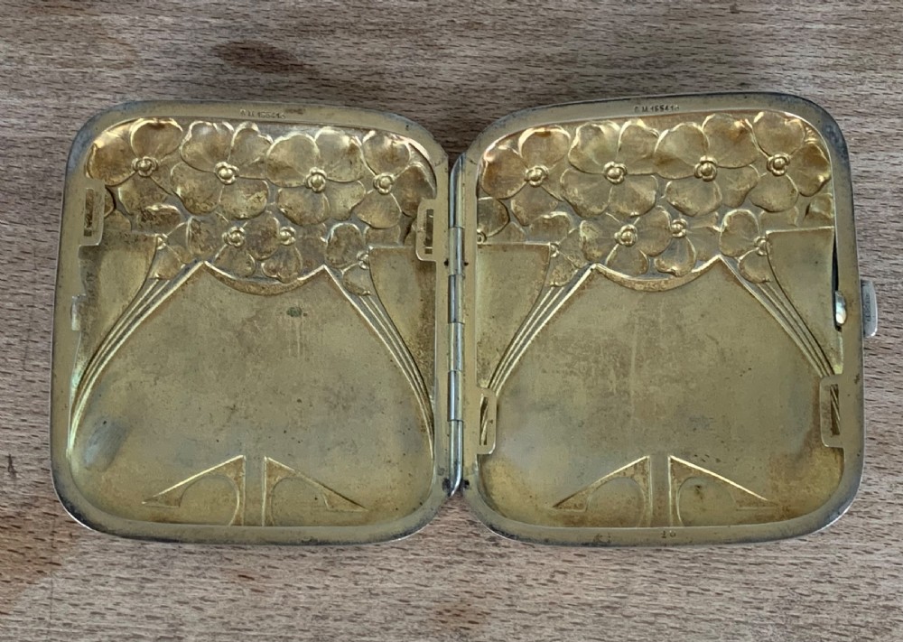 An antique German silver cigarette case featuring embossed Jugendstil floral motifs and flowing organic lines. View VI