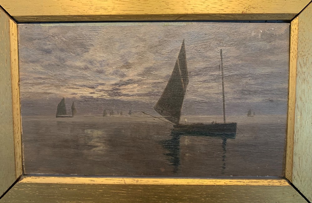 A 19th-century oil painting on board depicting sailing vessels on calm waters under an overcast sky, framed in a wide gilt frame. View II