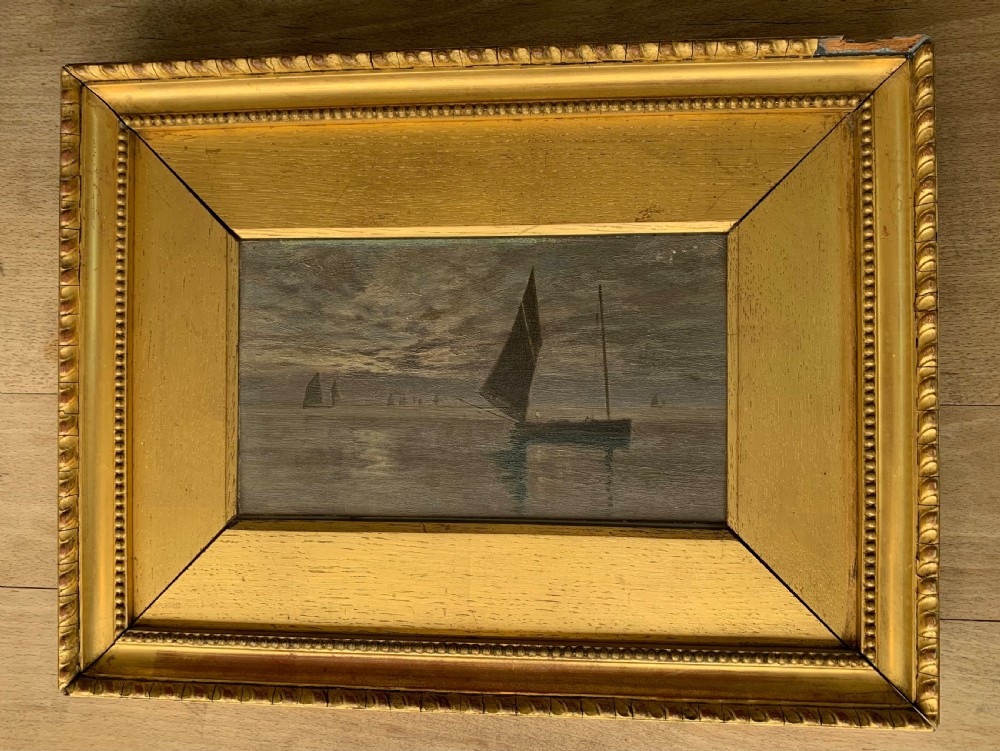 A 19th-century oil painting on board depicting sailing vessels on calm waters under an overcast sky, framed in a wide gilt frame. View XII