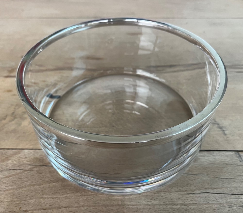A cylindrical clear glass bowl featuring a smooth polished sterling silver rim around the top edge. View II